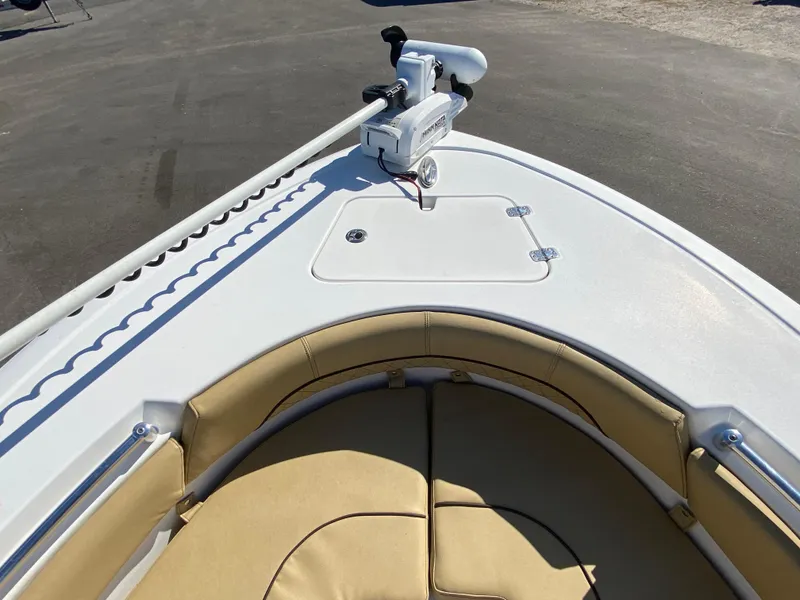 Slide: The Image of 2021 Sportsman Heritage 211 Center Console boat with tan seating and trolling motor. - 21