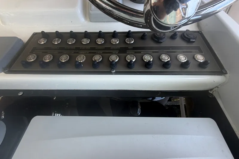 Slide: The Image of Control panel of a 2021 Tidewater 272 CC Adventure boat with multiple switches. - 16