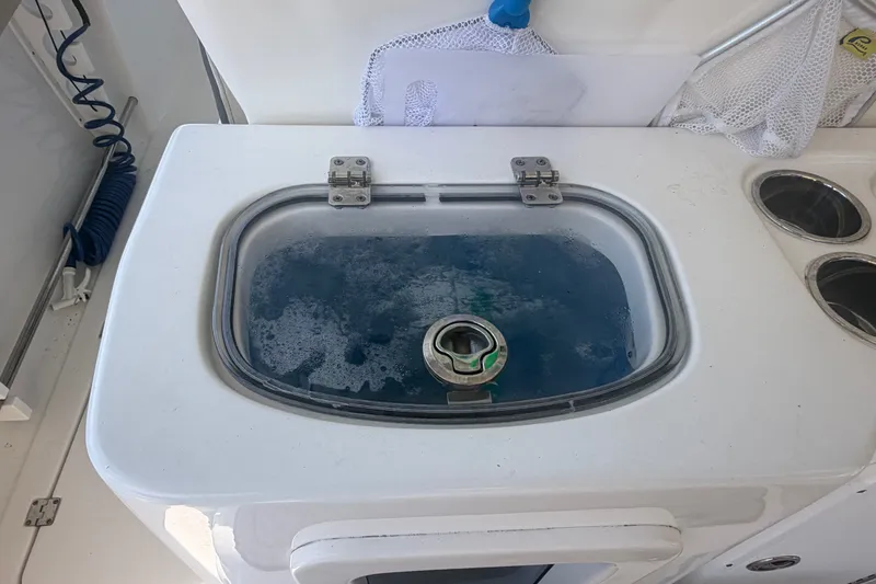Slide: The Image of Livewell on 2021 Tidewater 272 CC Adventure boat, filled with water. - 40