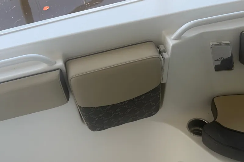 Slide: The Image of 2021 Tidewater 272 CC Adventure boat interior with cushioned seating and cup holder. - 25