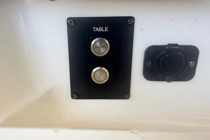 Slide: The Image of Control panel with buttons labeled "Table" on a 2021 Tidewater 272 CC Adventure boat. - 45