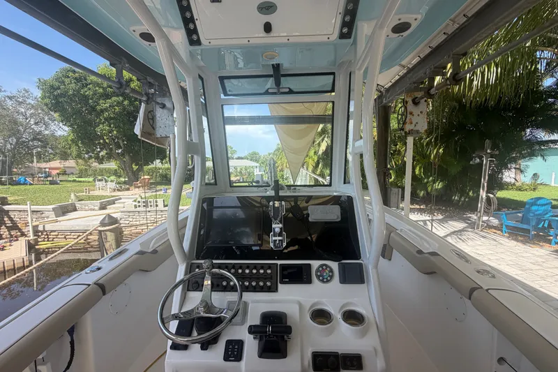 Slide: The Image of 2021 Tidewater 272 CC Adventure boat cockpit with steering wheel and control panel. - 14