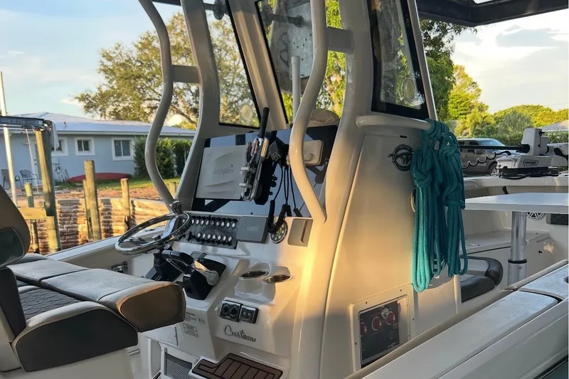 Slide: The Image of 2021 Tidewater 272 CC Adventure boat interior with steering wheel and control panel. - 7