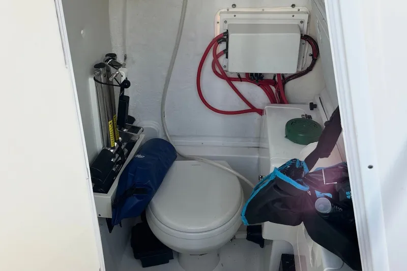Slide: The Image of Interior of 2021 Tidewater 272 CC Adventure boat with marine toilet and storage. - 15