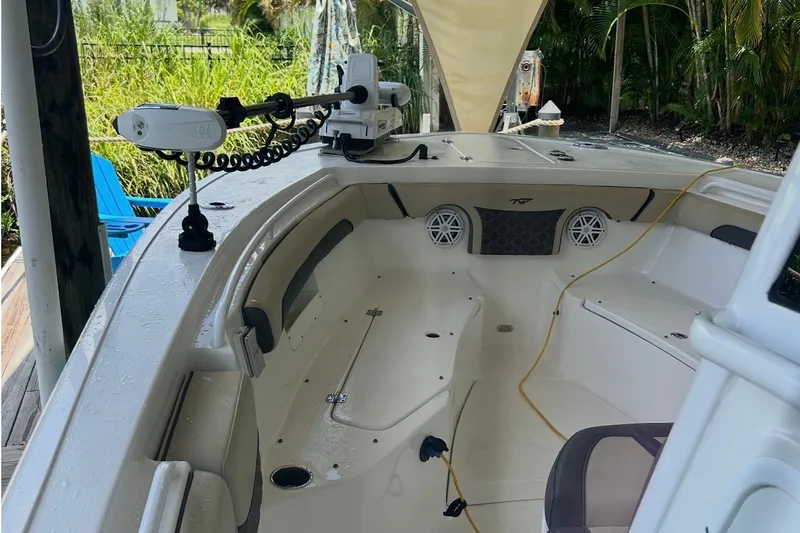 Slide: The Image of 2021 Tidewater 272 CC Adventure boat interior with seating and fishing equipment. - 9