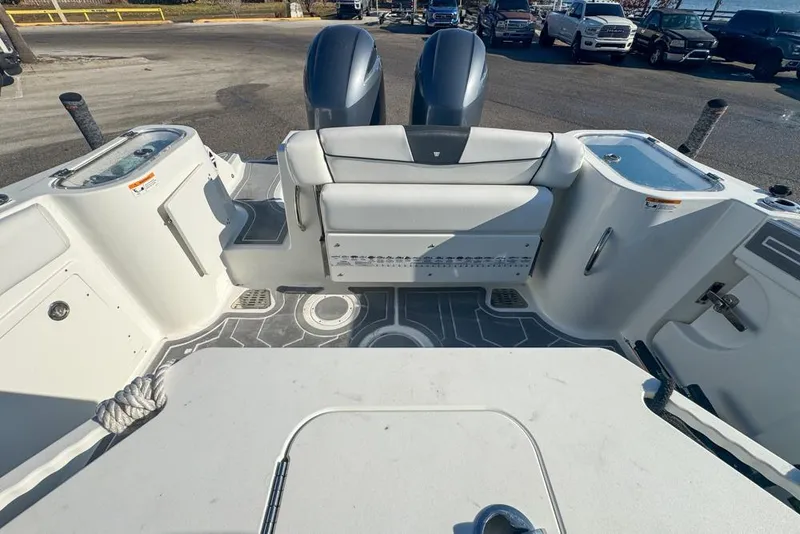 Slide: The Image of 2021 Wellcraft 262 Fisherman boat interior with seating and dual engines. - 29