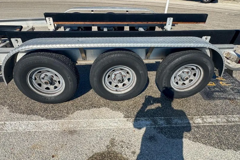 Slide: The Image of Triple-axle trailer for 2021 Wellcraft 262 Fisherman boat in parking lot. - 102