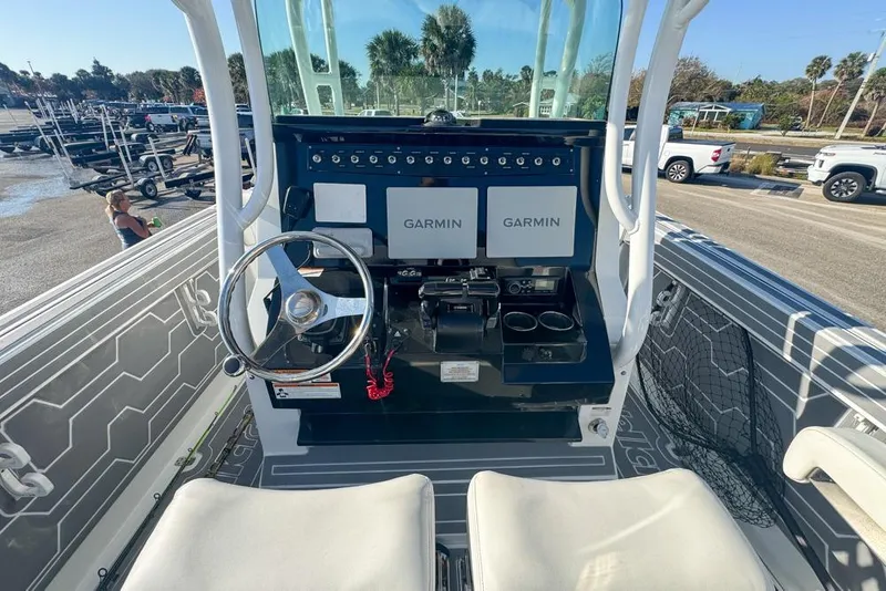 Slide: The Image of 2021 Wellcraft 262 Fisherman boat dashboard with Garmin displays and steering wheel. - 51