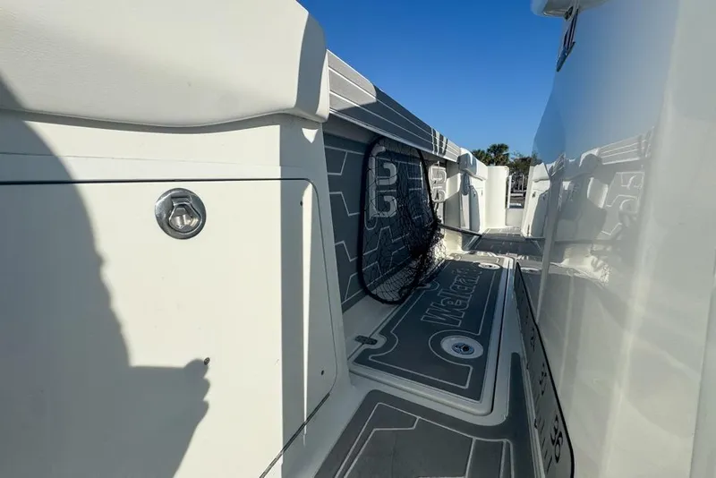 Slide: The Image of 2021 Wellcraft 262 Fisherman boat deck with storage compartment and netting. - 89