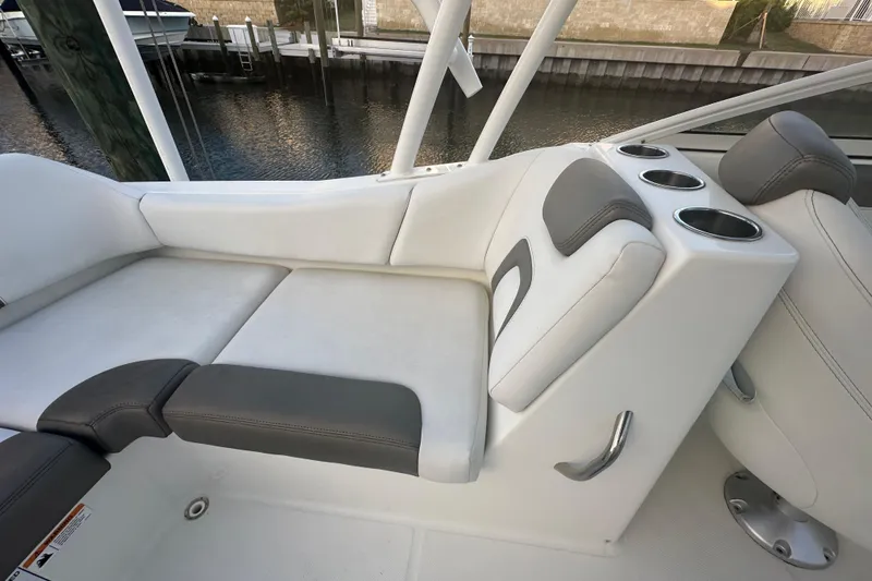 Slide: The Image of 2021 World Cat 230 SD boat interior with cushioned seating and cup holders. - 66