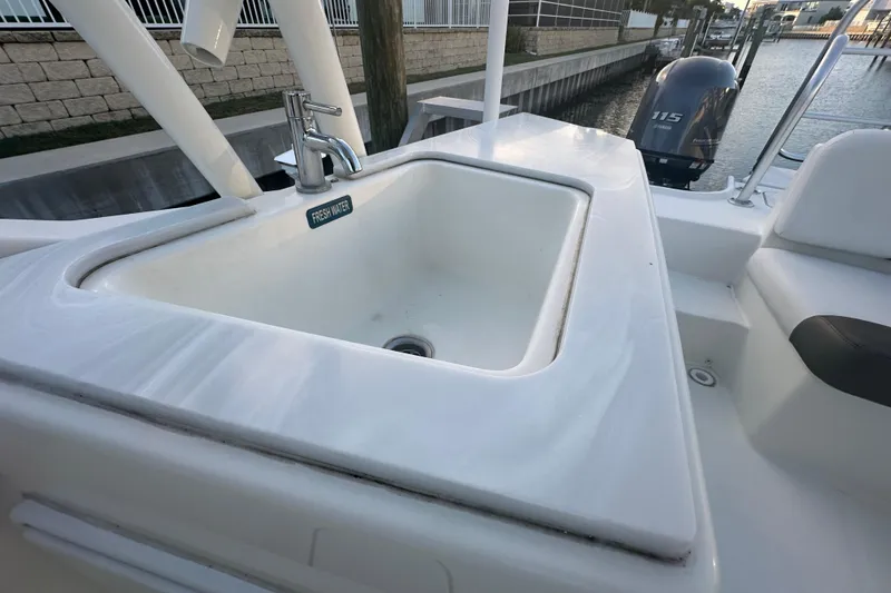 Slide: The Image of Freshwater sink on 2021 World Cat 230 SD boat, docked with Yamaha 115 outboard motor. - 61