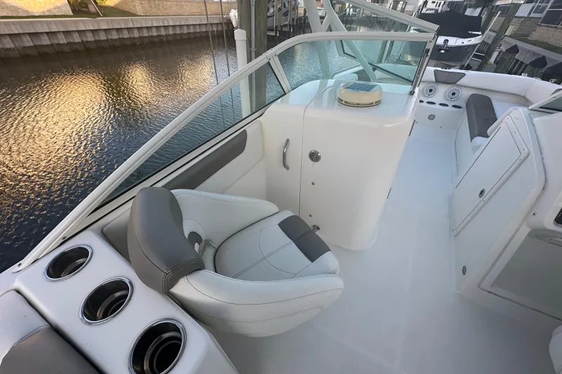 Slide: The Image of 2021 World Cat 230 SD boat interior with seating and cup holders. - 19