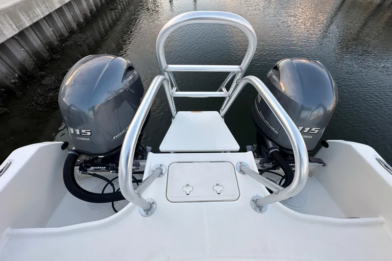 Slide: The Image of 2021 World Cat 230 SD boat with dual Yamaha 115 engines, docked by water. - 94