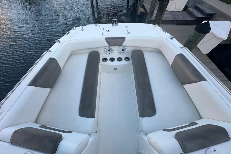 Slide: The Image of 2021 World Cat 230 SD boat interior with white and gray seating, docked by the water. - 35