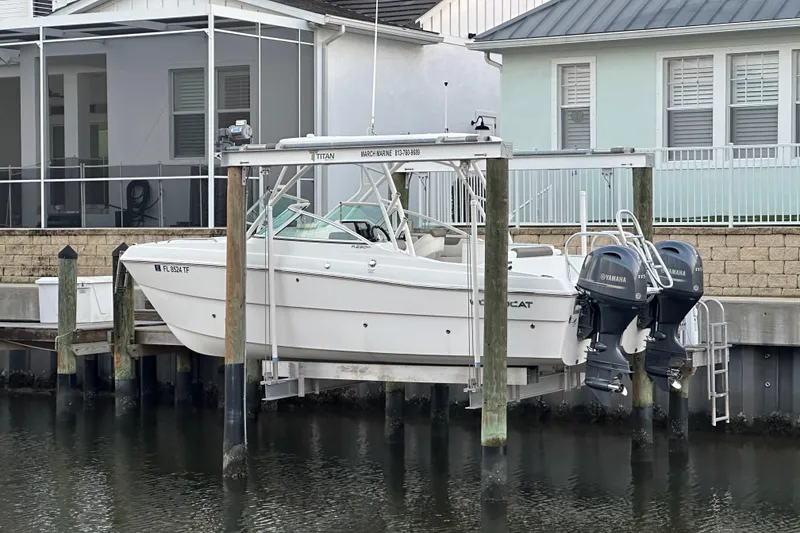 Slide: The Image of 2021 World Cat 230 SD boat on lift, docked by waterfront homes. - 118