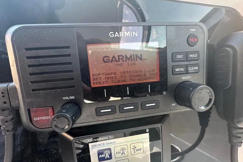 Slide: The Image of Garmin VHF 115 radio on 2021 World Cat 230 SD boat dashboard. - 24
