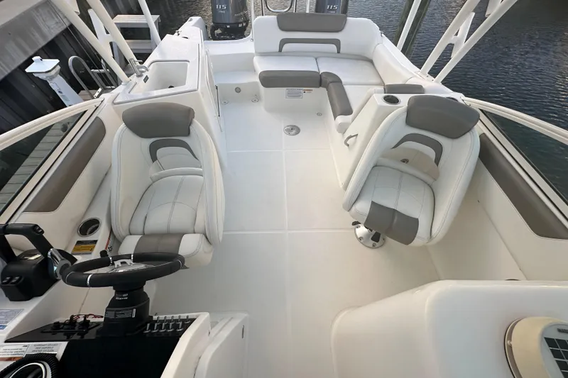 Slide: The Image of 2021 World Cat 230 SD boat interior with seating and steering wheel. - 52