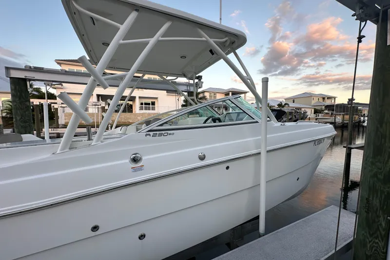Slide: The Image of 2021 World Cat 230 SD boat docked at sunset, showcasing sleek design. - 111