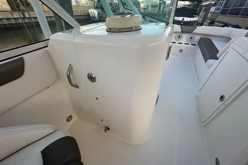 Slide: The Image of 2021 World Cat 230 SD boat interior with seating and storage compartments. - 69