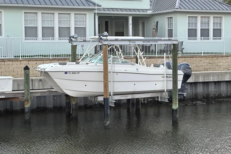 Slide: The Image of 2021 World Cat 230 SD boat docked on lift near waterfront home. - 116