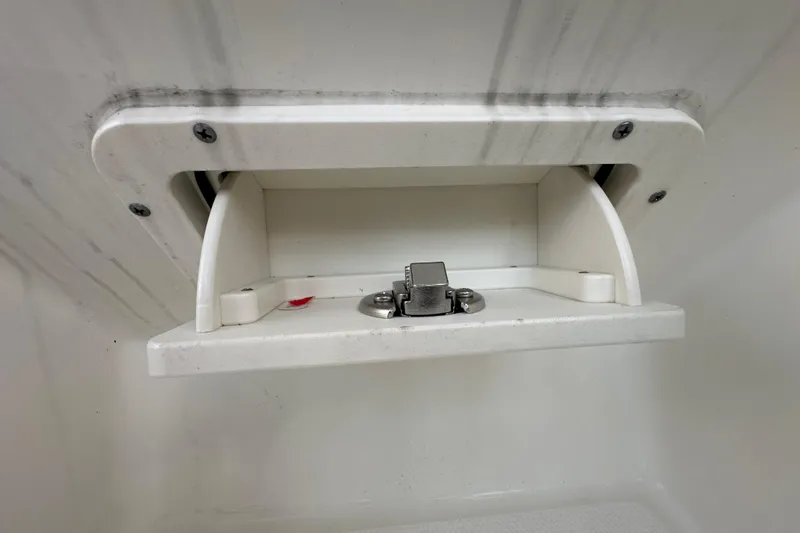 Slide: The Image of Storage compartment on a 2021 World Cat 230 SD boat, featuring a secure latch. - 97