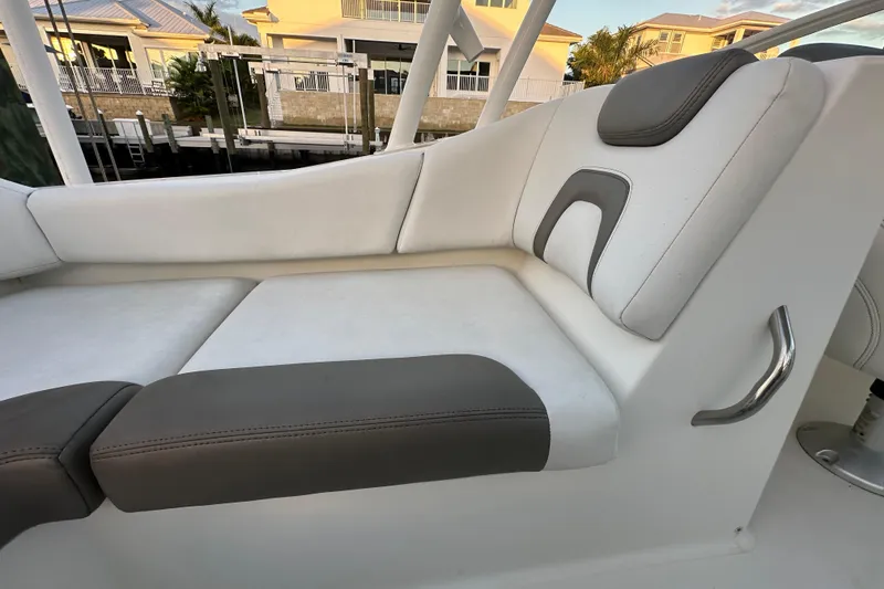 Slide: The Image of Luxurious seating on 2021 World Cat 230 SD boat, featuring white and gray upholstery. - 80