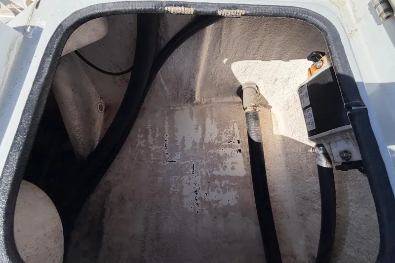 Slide: The Image of 2020 Blazer Bay 2200 Fisherman boat compartment with hoses and equipment. - 65