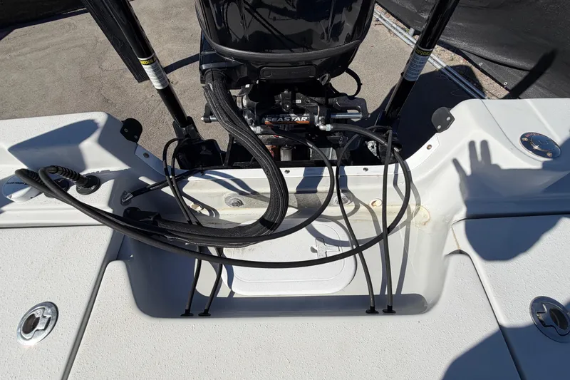 Slide: The Image of 2020 Blazer Bay 2200 Fisherman boat engine area with cables and hydraulic system. - 69