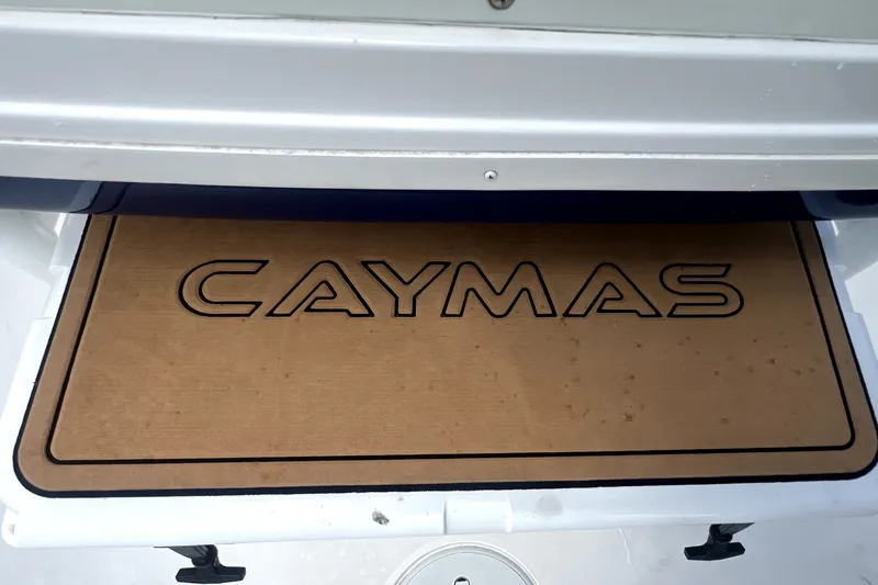 Slide: The Image of Caymas 26 HB 2020 boat deck with logo, showcasing sleek design. - 77