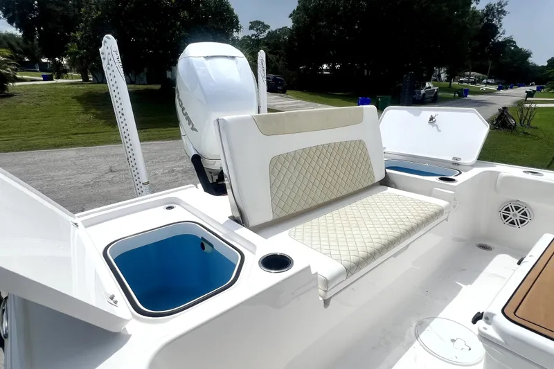 Slide: The Image of 2020 Caymas 26 HB boat interior with cushioned seating and storage compartments. - 88