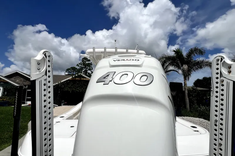 Slide: The Image of 2020 Caymas 26 HB boat with 400 Verado engine, under a vibrant blue sky. - 16