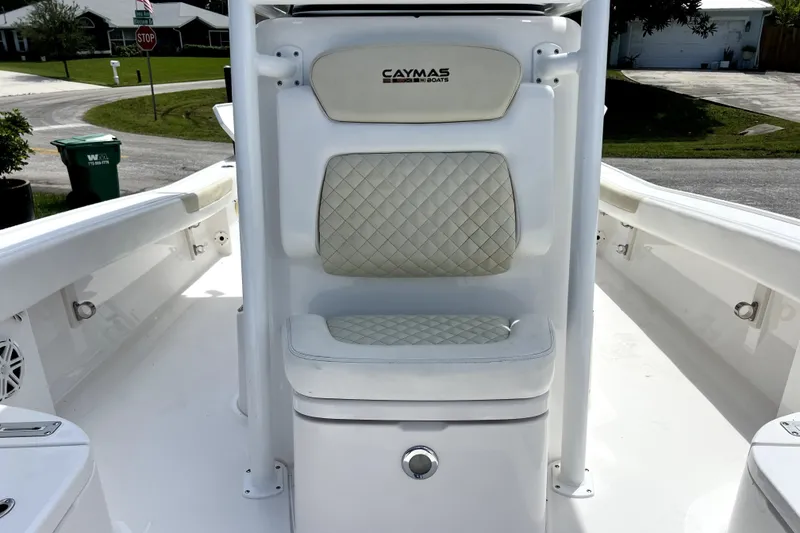 Slide: The Image of 2020 Caymas 26 HB boat with cushioned seating and storage compartment. - 50