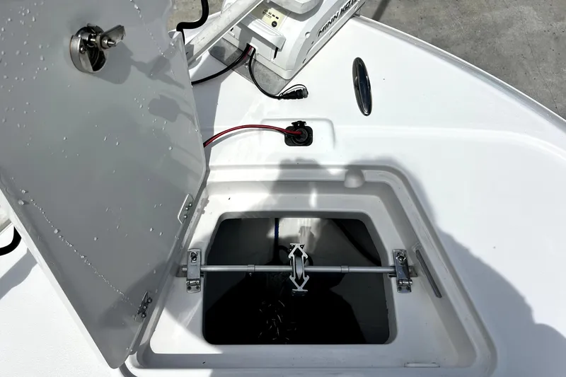 Slide: The Image of Open hatch on 2020 Caymas 26 HB boat, revealing storage compartment and wiring. - 59