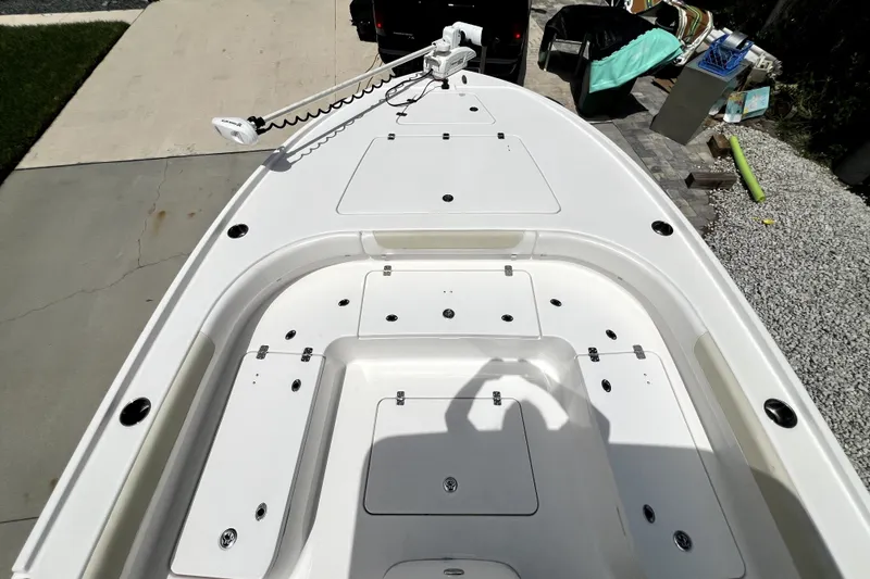 Slide: The Image of 2020 Caymas 26 HB boat deck with storage compartments and trolling motor. - 87