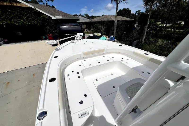 Slide: The Image of 2020 Caymas 26 HB boat with spacious deck, parked outdoors. - 67