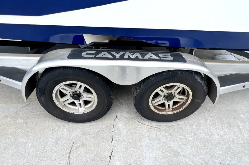Slide: The Image of Trailer wheels of a 2020 Caymas 26 HB boat on concrete surface. - 71