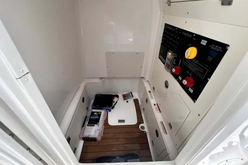 Slide: The Image of 2020 Caymas 26 HB boat interior with control panel and storage area. - 61