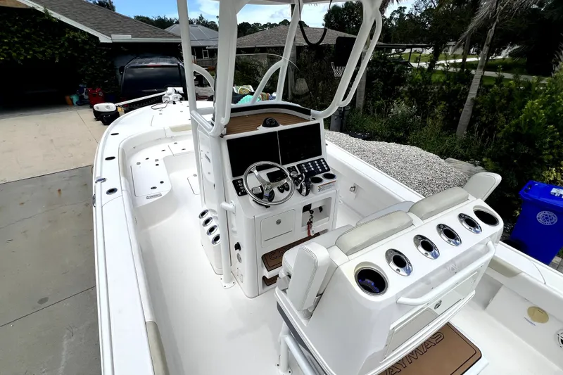 Slide: The Image of 2020 Caymas 26 HB boat interior with helm, seating, and control panel. - 30