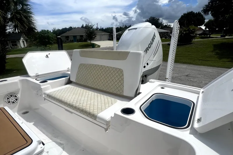 Slide: The Image of 2020 Caymas 26 HB boat with Mercury engine, featuring cushioned seating and storage compartments. - 91