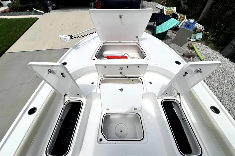 Slide: The Image of 2020 Caymas 26 HB boat with open storage compartments on deck. - 78