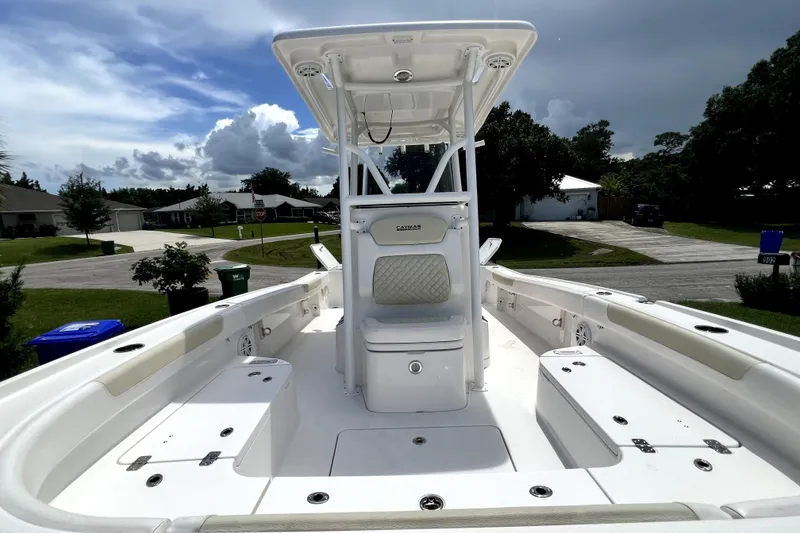 Slide: The Image of 2020 Caymas 26 HB boat with spacious deck and T-top under a cloudy sky. - 57