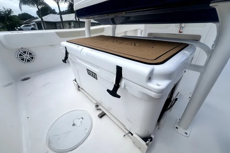 Slide: The Image of 2020 Caymas 26 HB boat deck with YETI cooler and storage compartment. - 79