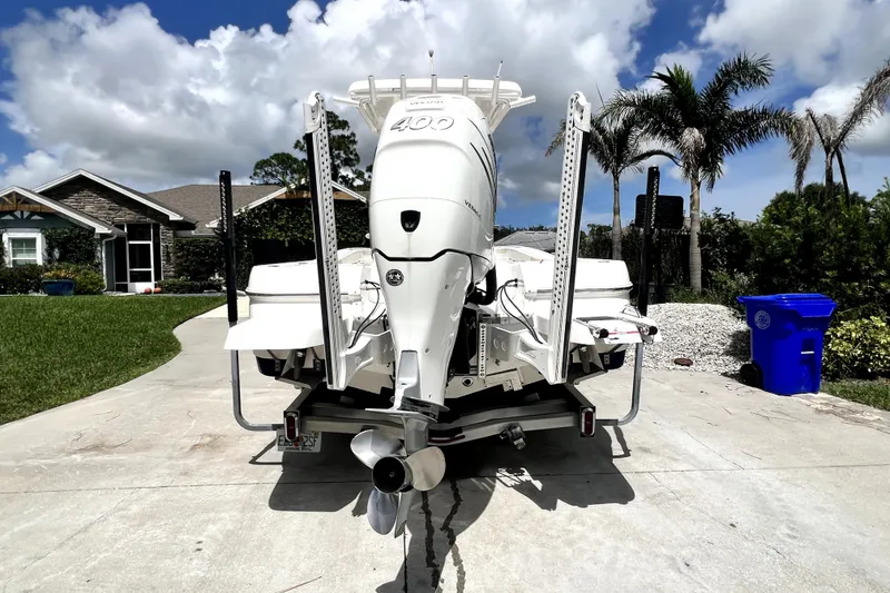 Slide: The Image of 2020 Caymas 26 HB boat with powerful outboard motor on driveway. - 3