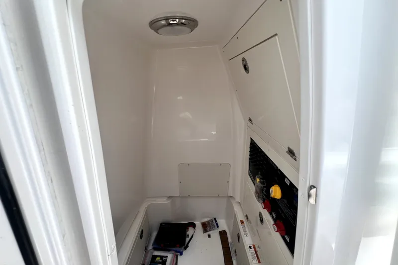 Slide: The Image of Interior view of 2020 Caymas 26 HB boat compartment with storage and control panel. - 62