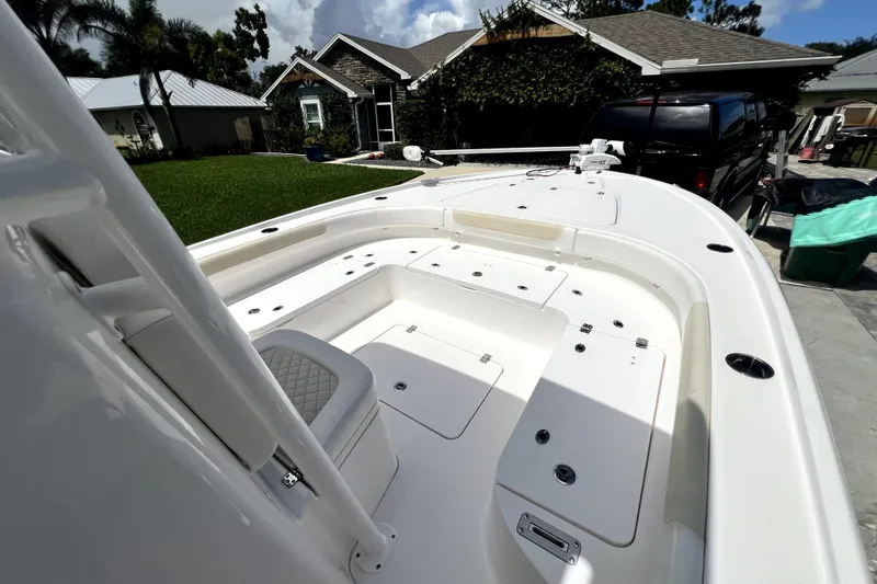 Slide: The Image of 2020 Caymas 26 HB boat parked in a residential driveway, showcasing spacious deck layout. - 73