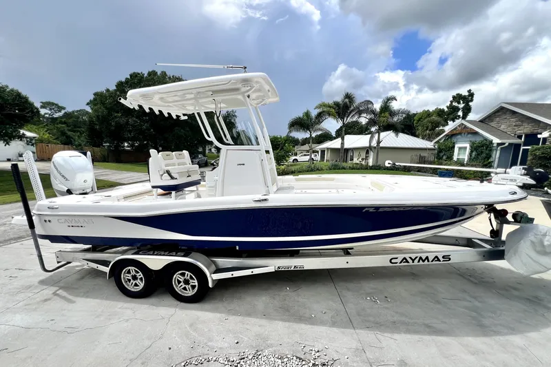Slide: The Image of 2020 Caymas 26 HB boat on trailer, parked in residential driveway. - 6