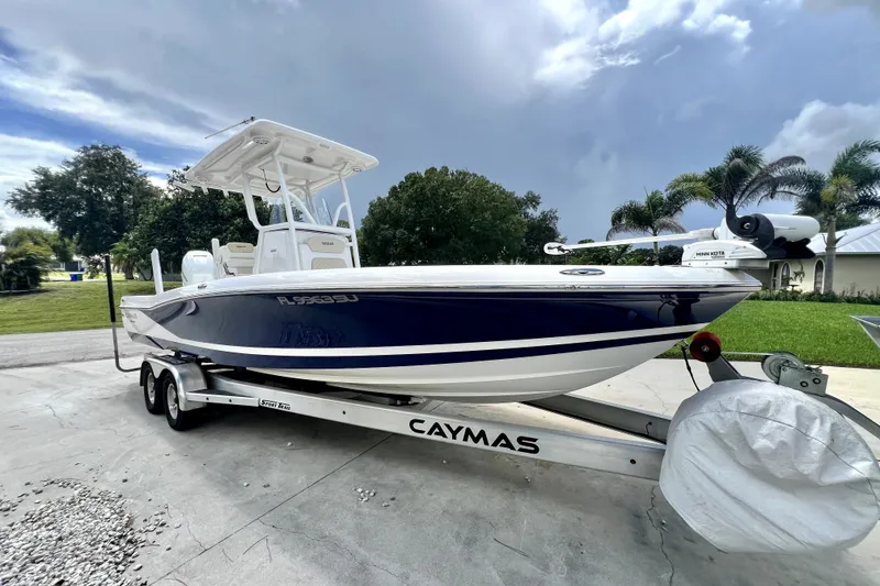 Slide: The Image of 2020 Caymas 26 HB boat on trailer, parked outdoors under cloudy sky. - 4