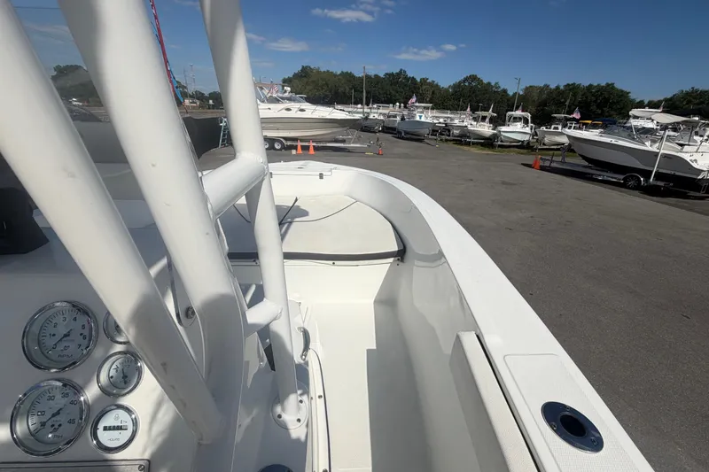 Slide: The Image of 2020 Clearwater 2000 Center Console boat at marina, showcasing dashboard and seating area. - 46
