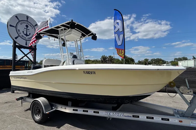 The Image of 2020 Clearwater 2000 Center Console boat on trailer, displayed outdoors under blue sky. - 1