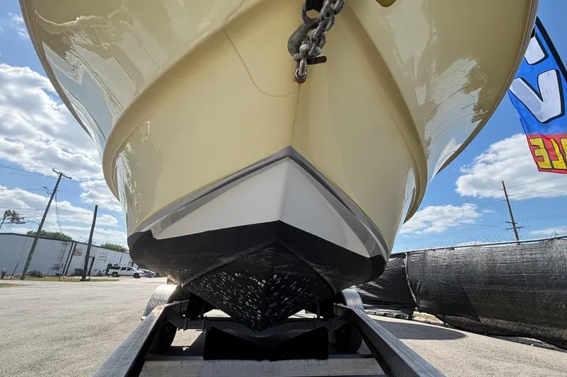 Slide: The Image of 2020 Clearwater 2000 Center Console boat on trailer, viewed from below, with blue sky background. - 14